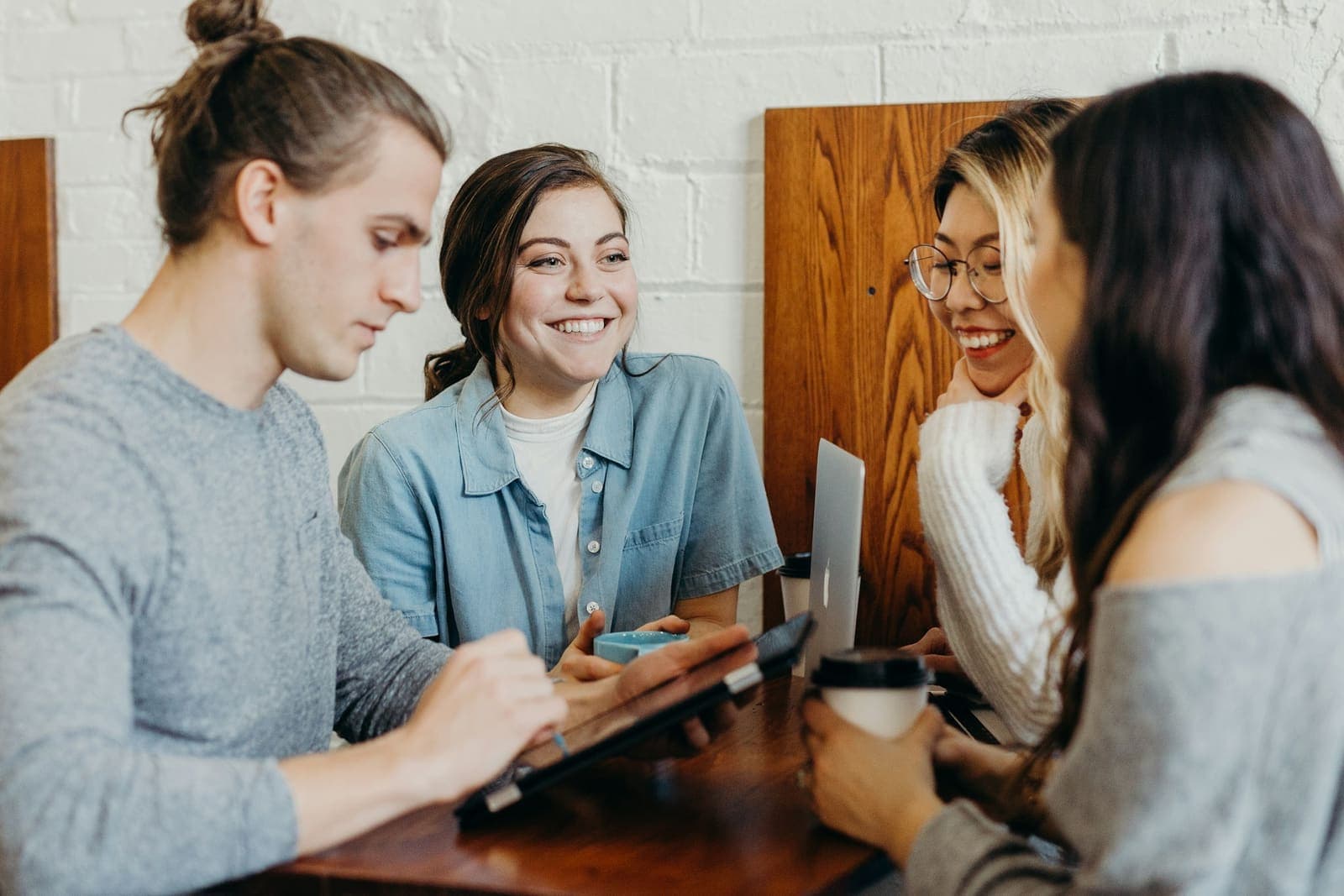 Friends sharing something on their phones around a table