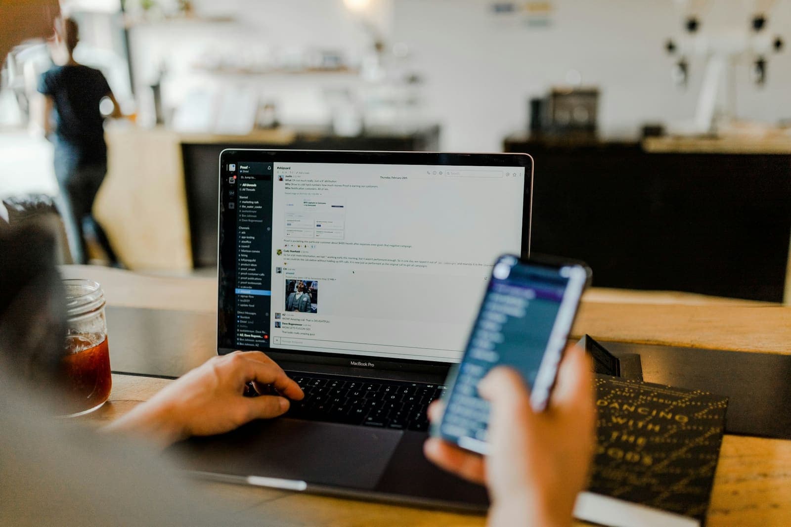 Testing a mobile app on a phone next to a laptop